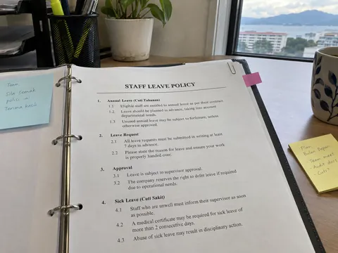Staff leave policy in a ring binder, a reference for HR questions.