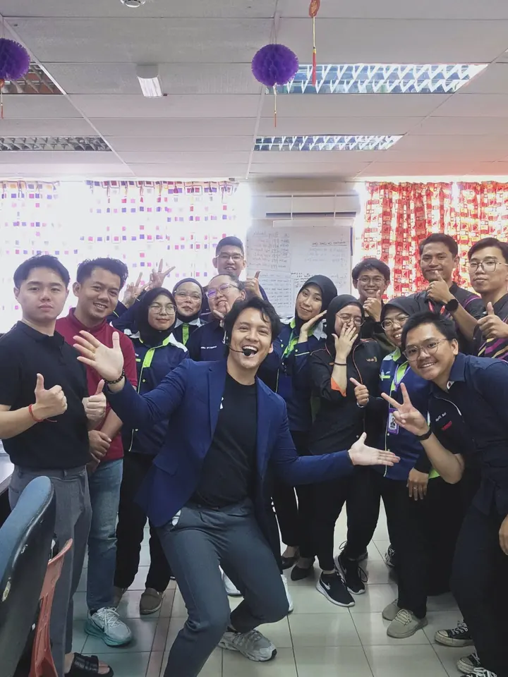 Edison Chua with the participants of a past NextGen class, smiling and giving thumbs up.