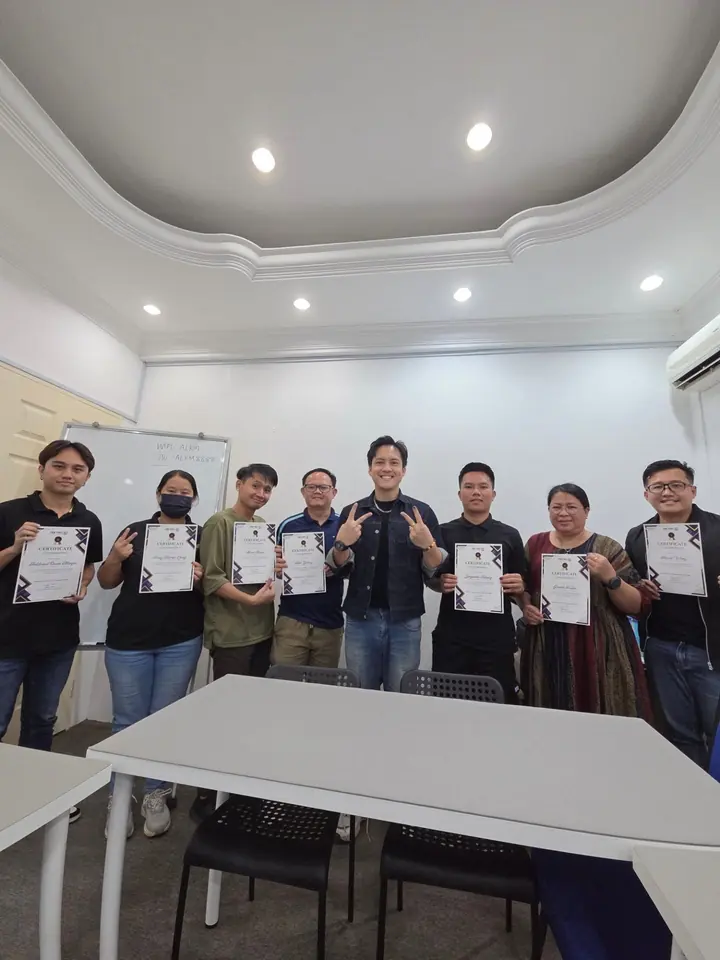 Edison Chua with students of a past NextGen class, each holding a certificate.