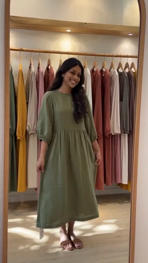 Boutique video featuring a woman presenting a green dress